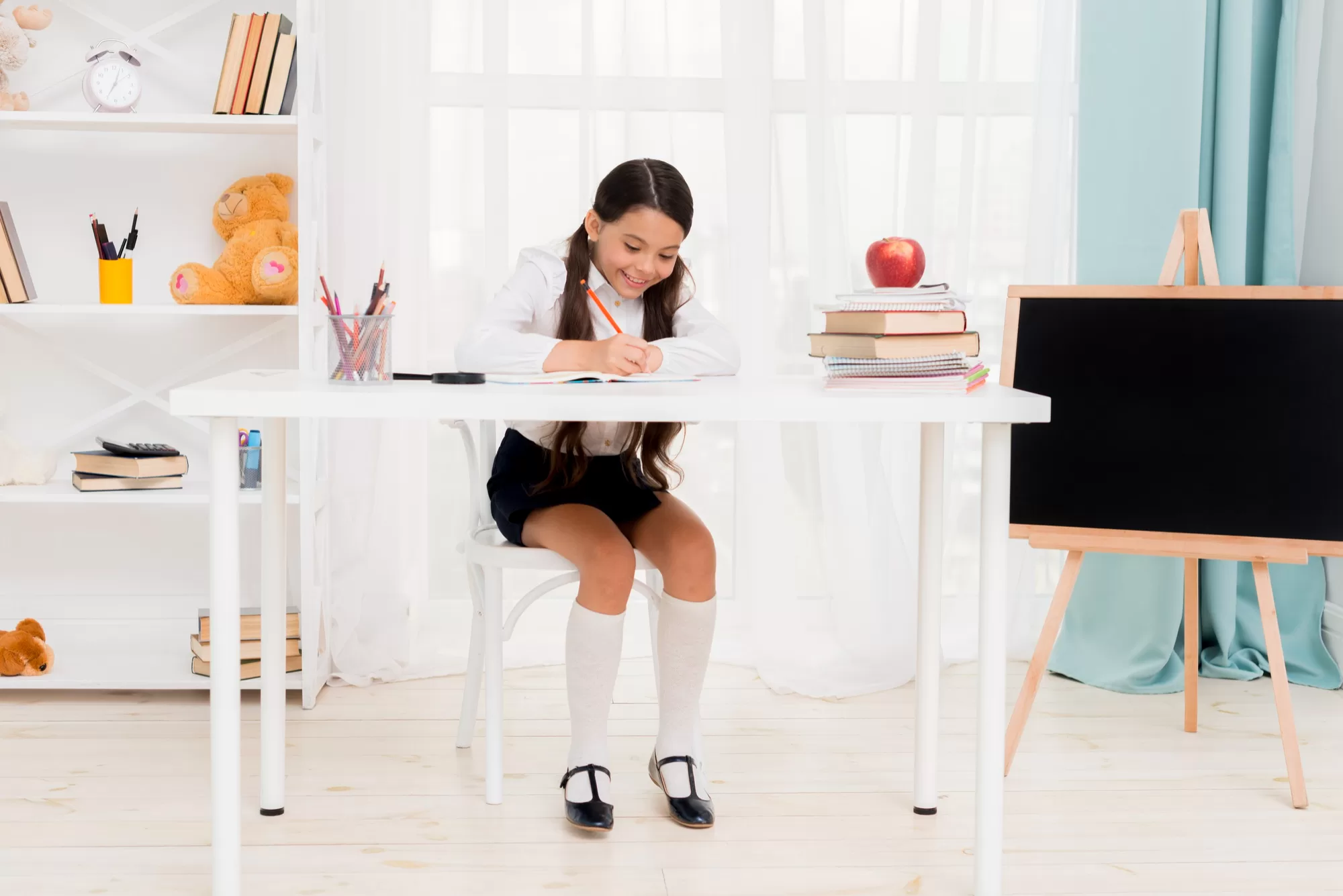 Cute School Girl Sitting on Desk