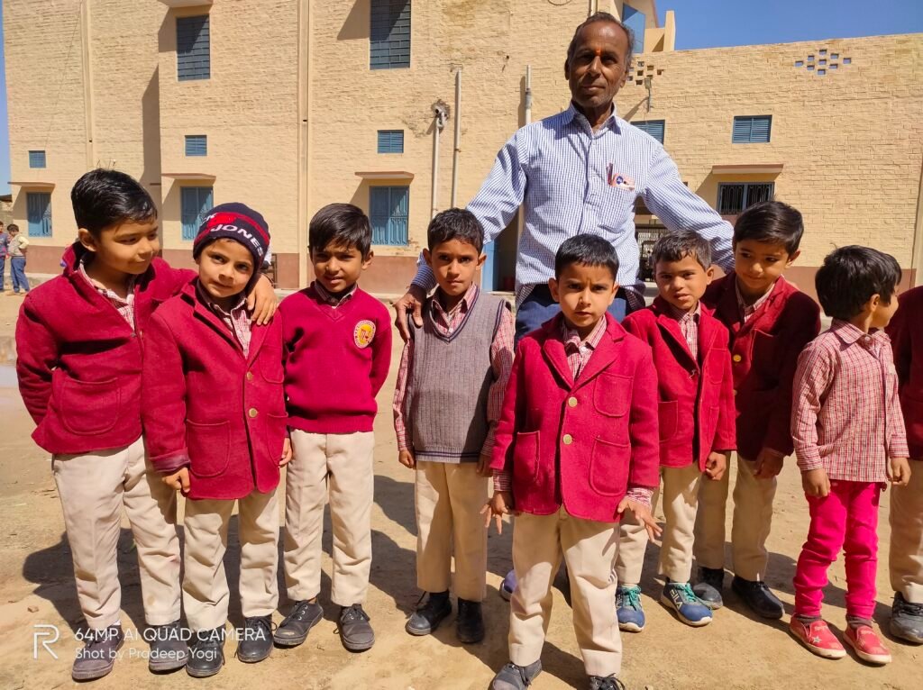 A teacher with his students, standing in school campus.